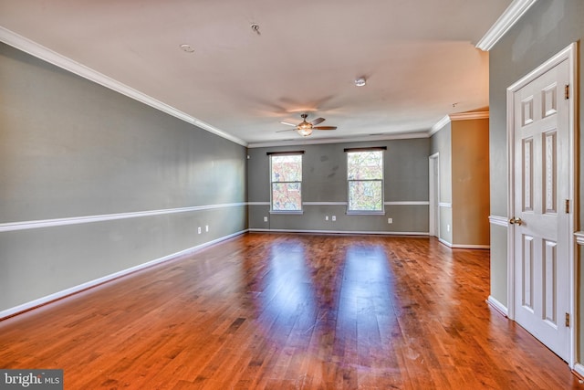 unfurnished room with baseboards, ceiling fan, ornamental molding, and wood finished floors