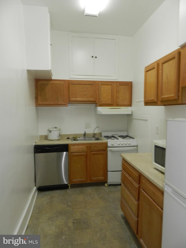 kitchen with a sink, light countertops, white appliances, under cabinet range hood, and brown cabinetry
