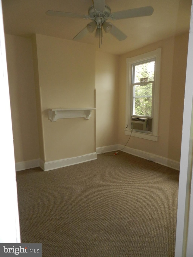 unfurnished room with baseboards, a ceiling fan, carpet flooring, and cooling unit