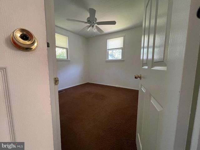 5714 63rd Ave, Riverdale, MD 20737 - unfurnished room with dark carpet, plenty of natural light, and baseboards
