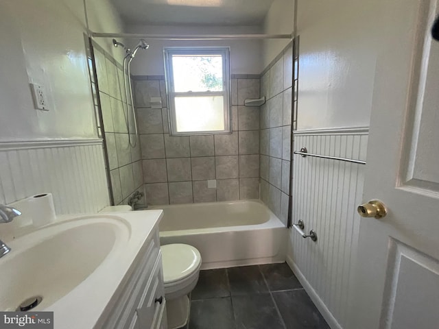 5714 63rd Ave, Riverdale, MD 20737 - bathroom featuring vanity, toilet, tile patterned floors, bathing tub / shower combination, and a wainscoted wall