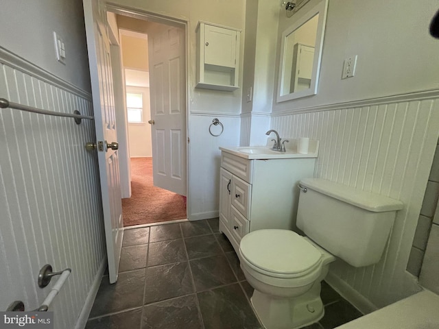 5714 63rd Ave, Riverdale, MD 20737 - bathroom with toilet, vanity, and a wainscoted wall