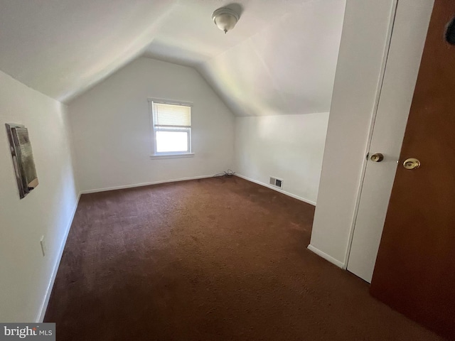 5714 63rd Ave, Riverdale, MD 20737 - bonus room with dark colored carpet, lofted ceiling, and baseboards
