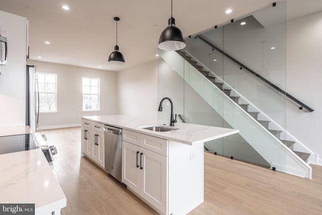 4030 Marilyn Dr, Philadelphia, PA 19131 - kitchen with stainless steel appliances, light wood finished floors, white cabinetry, and a sink