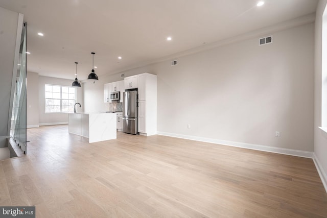 4030 Marilyn Dr, Philadelphia, PA 19131 - unfurnished living room with light wood-type flooring, baseboards, visible vents, and recessed lighting