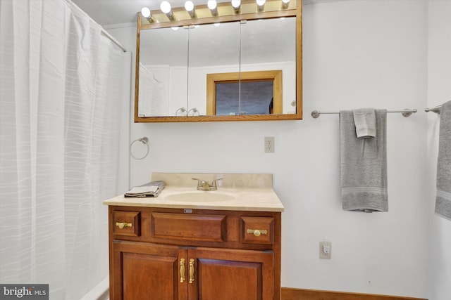 bathroom with curtained shower and vanity