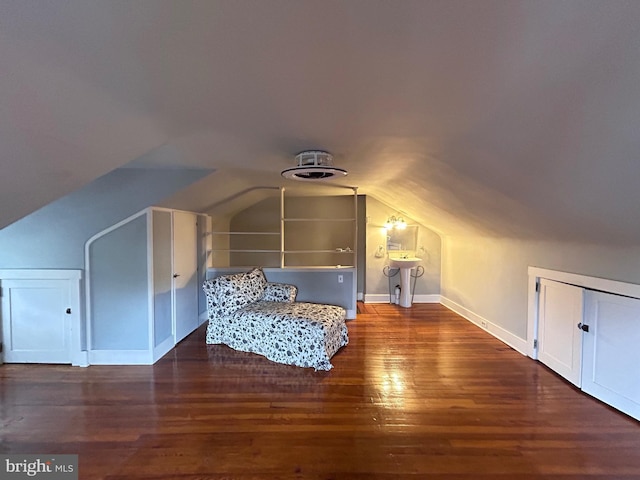 additional living space featuring baseboards, vaulted ceiling, and wood finished floors