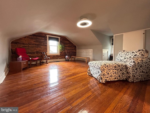 bedroom with hardwood / wood-style flooring, baseboards, and vaulted ceiling
