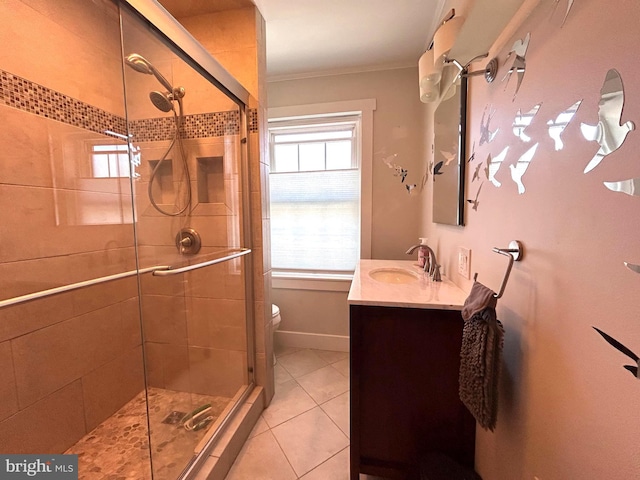 bathroom with tile patterned flooring, toilet, vanity, ornamental molding, and a stall shower