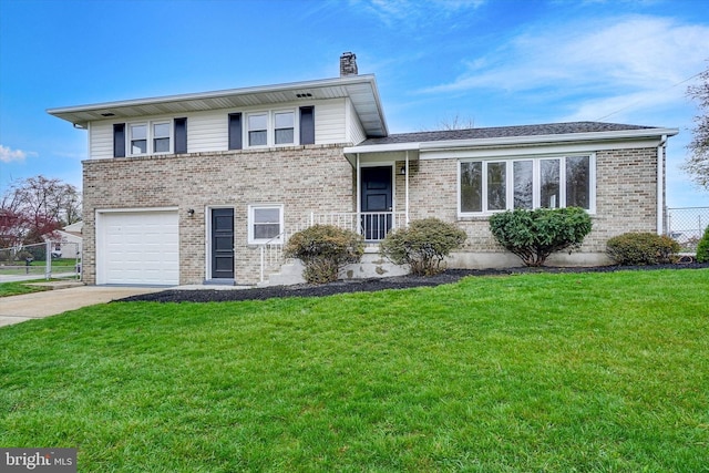 22 Spring Ridge Dr, York, PA 17408 - tri-level home with a garage, a front yard, concrete driveway, and brick siding