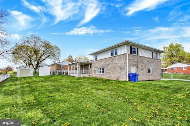 22 Spring Ridge Dr, York, PA 17408 - back of property with an outbuilding, a lawn, a storage unit, fence, and brick siding