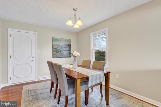 22 Spring Ridge Dr, York, PA 17408 - dining room with wood finished floors, an inviting chandelier, baseboards, and visible vents