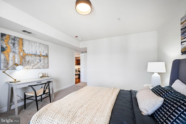 bedroom featuring visible vents, baseboards, and carpet