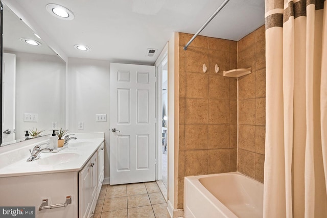 bathroom with shower / tub combo, tile patterned floors, a sink, and visible vents