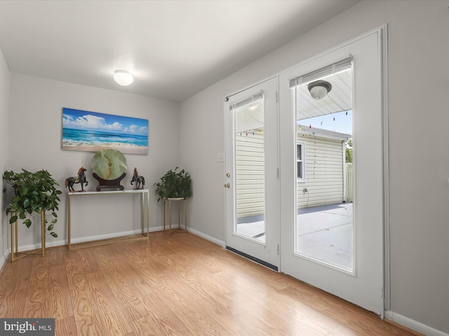 entryway featuring wood finished floors and baseboards