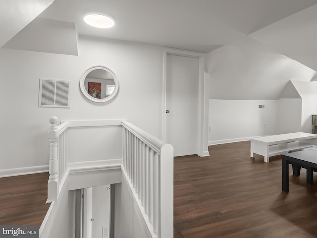 additional living space featuring wood finished floors, lofted ceiling, and baseboards