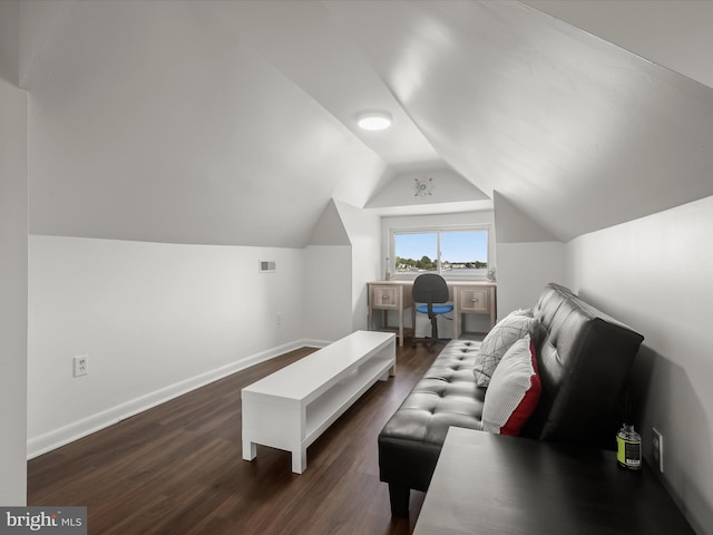 living area featuring dark wood finished floors, lofted ceiling, and baseboards