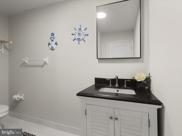 half bathroom with vanity, baseboards, toilet, and marble look tile flooring