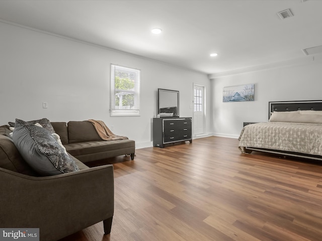 bedroom featuring wood finished floors, baseboards, and recessed lighting