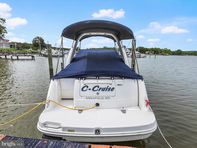 dock area featuring boat lift and a water view
