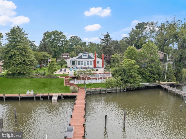 dock area with a yard, stairway, and a deck with water view