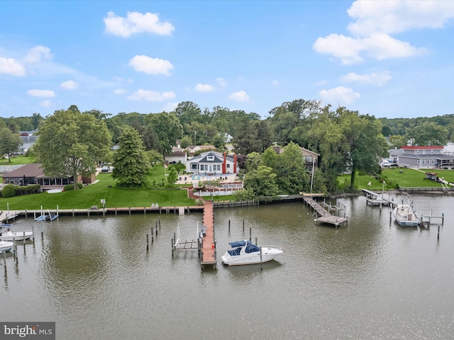 dock with a water view and view of wooded area