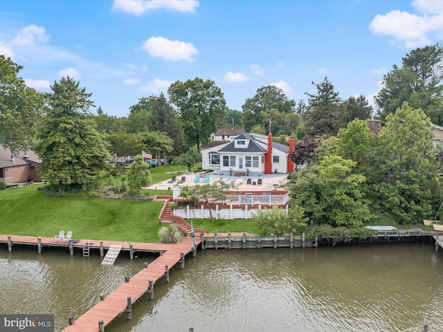 dock area with a water view, a patio area, and a yard