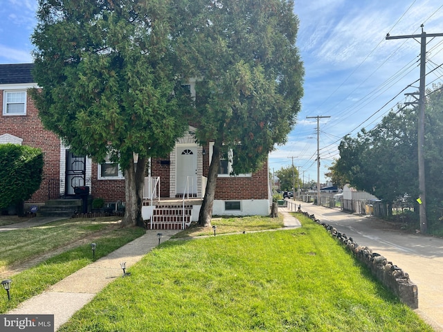 4301 Brehms Ln, Baltimore, MD 21206 - view of front facade with brick siding and a front lawn