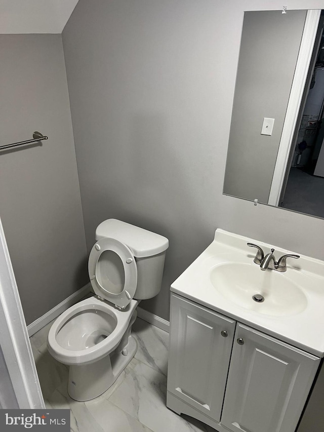 4301 Brehms Ln, Baltimore, MD 21206 - half bathroom with marble finish floors, toilet, vanity, and baseboards