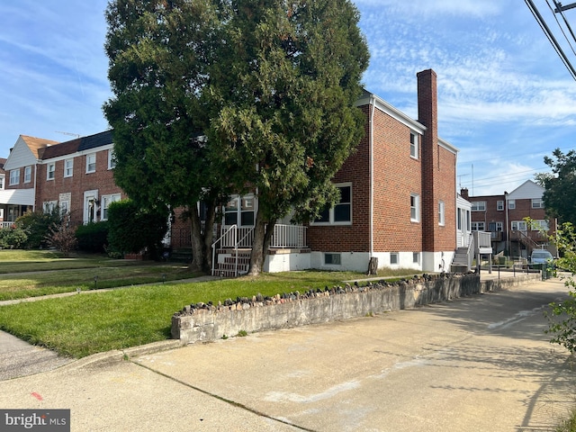 4301 Brehms Ln, Baltimore, MD 21206 - view of front of property featuring a front lawn, brick siding, a chimney, and a residential view