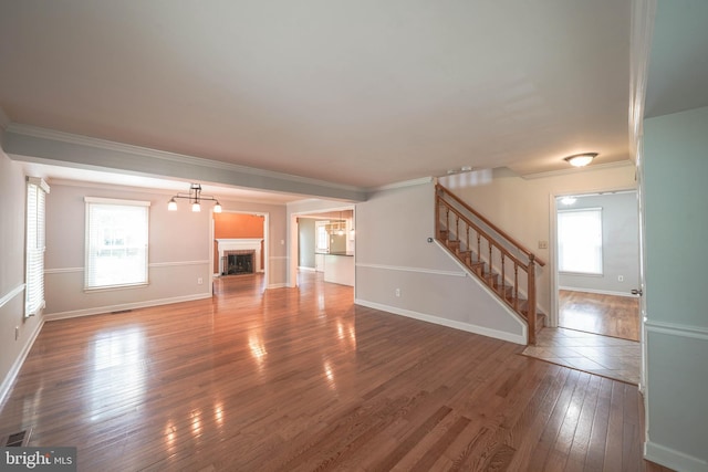 312 Fairgrove Ter, Gaithersburg, MD 20877 - unfurnished living room featuring hardwood / wood-style floors, stairway, ornamental molding, and a fireplace