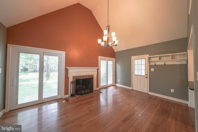 312 Fairgrove Ter, Gaithersburg, MD 20877 - unfurnished living room featuring high vaulted ceiling, a chandelier, hardwood / wood-style floors, and a fireplace