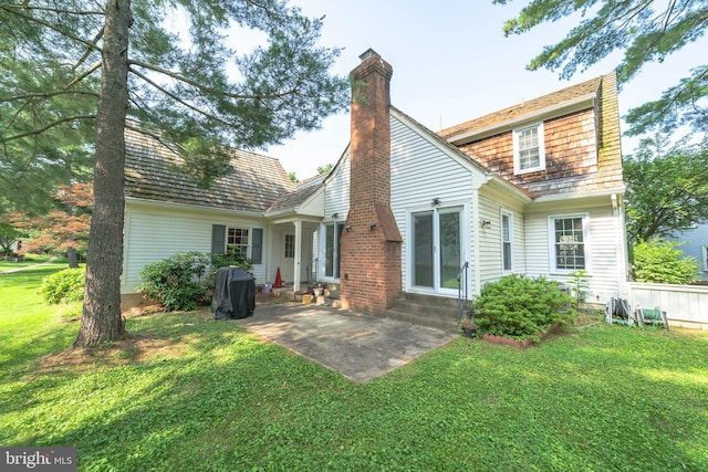 312 Fairgrove Ter, Gaithersburg, MD 20877 - back of house with entry steps, a chimney, a yard, and a patio area