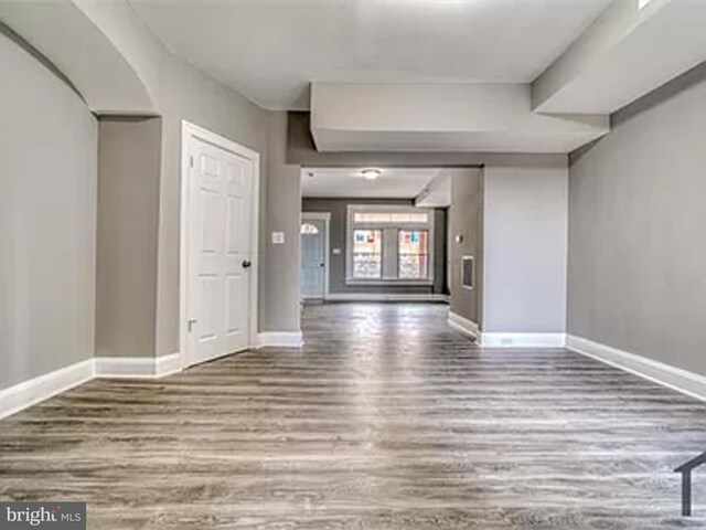 unfurnished room featuring wood finished floors and baseboards