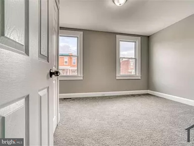 empty room with carpet floors and baseboards