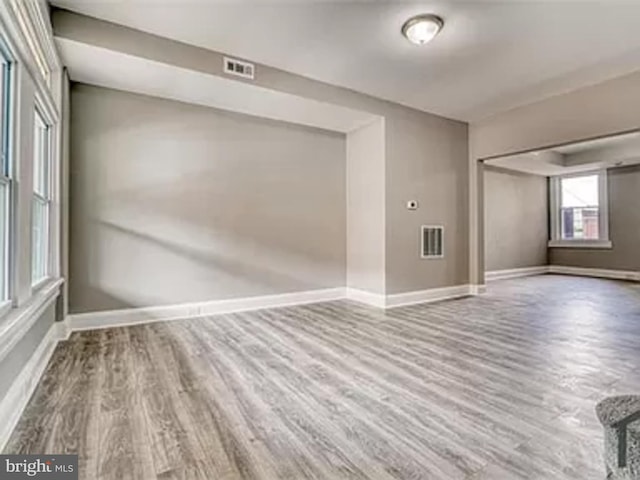 unfurnished room featuring wood finished floors and baseboards