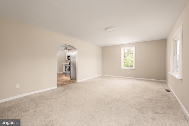 4808 Frazier Neck Rd, Preston, MD 21655 - empty room featuring arched walkways, visible vents, a ceiling fan, and light colored carpet