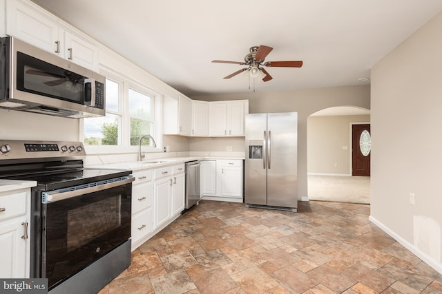 4808 Frazier Neck Rd, Preston, MD 21655 - kitchen featuring stainless steel appliances, arched walkways, a sink, a ceiling fan, and light countertops