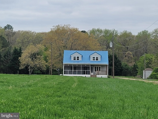 4808 Frazier Neck Rd, Preston, MD 21655 - back of property featuring a yard, a wooded view, a storage unit, a sunroom, and metal roof