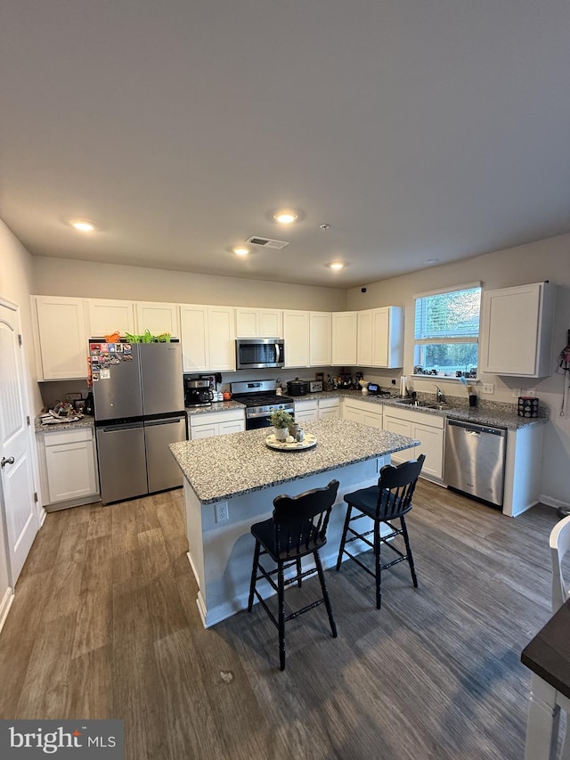 417 Lena Ln, Fruitland, MD 21826 - kitchen featuring stainless steel appliances, white cabinetry, light stone counters, and dark wood finished floors
