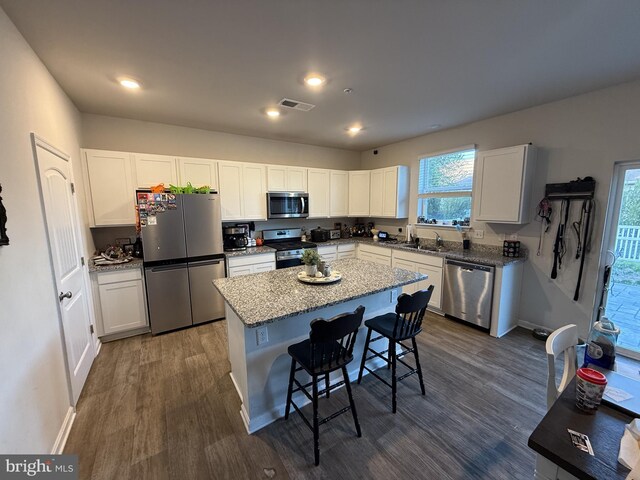 417 Lena Ln, Fruitland, MD 21826 - kitchen featuring a kitchen island, visible vents, a kitchen bar, dark wood finished floors, and appliances with stainless steel finishes