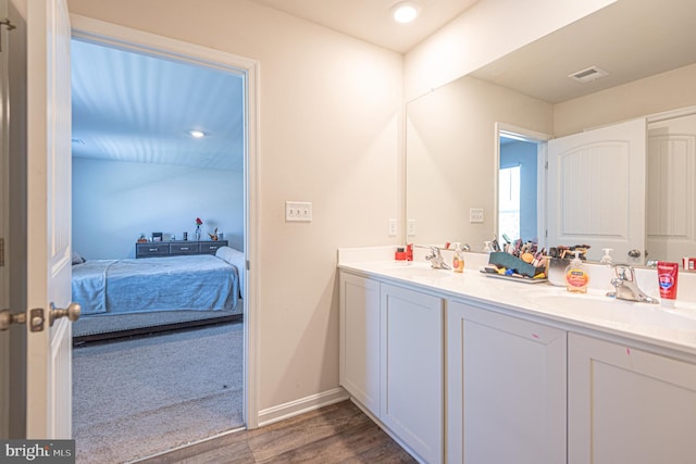 417 Lena Ln, Fruitland, MD 21826 - ensuite bathroom featuring double vanity, wood finished floors, ensuite bathroom, and a sink