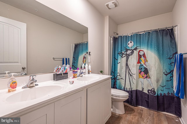 417 Lena Ln, Fruitland, MD 21826 - bathroom with toilet, wood finished floors, a sink, and visible vents