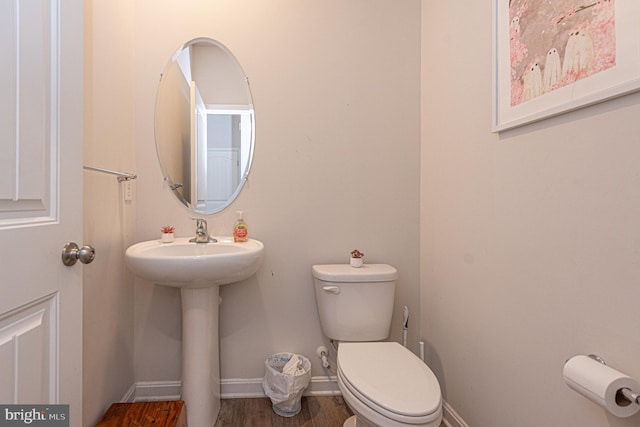 417 Lena Ln, Fruitland, MD 21826 - half bathroom featuring baseboards, wood finished floors, a sink, and toilet