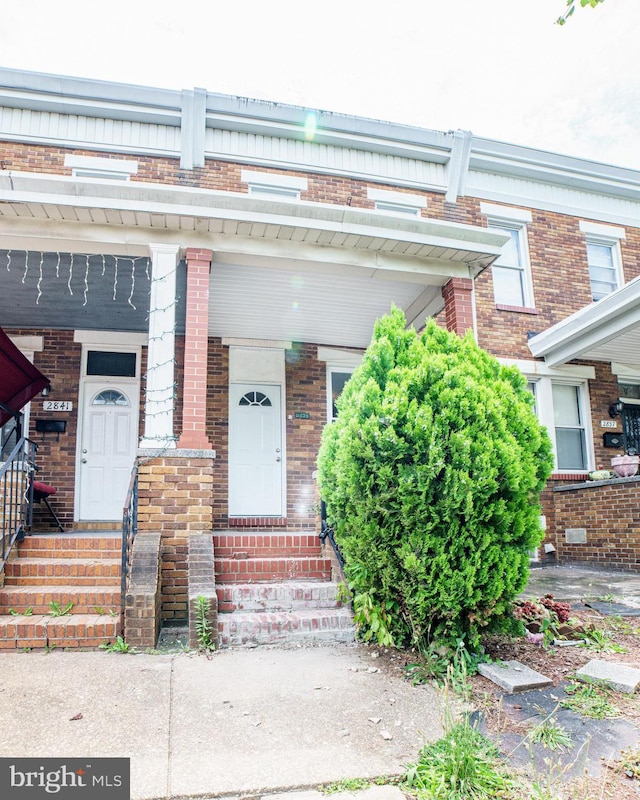 property entrance featuring brick siding