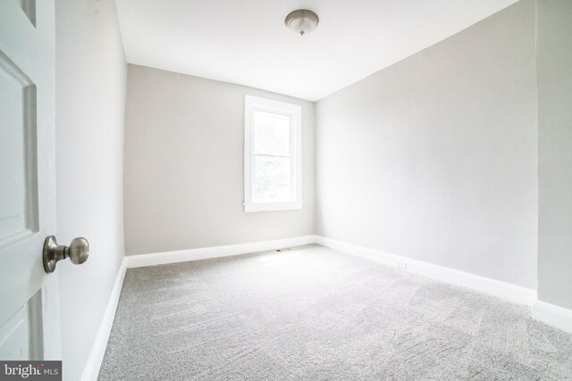 empty room with carpet and baseboards