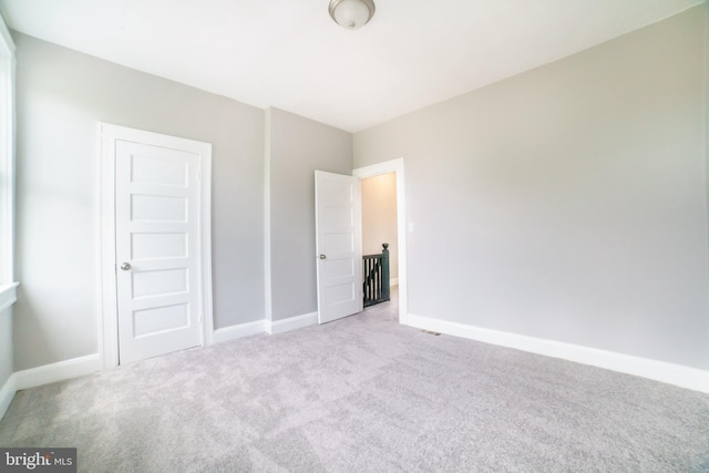 unfurnished bedroom with baseboards and carpet floors