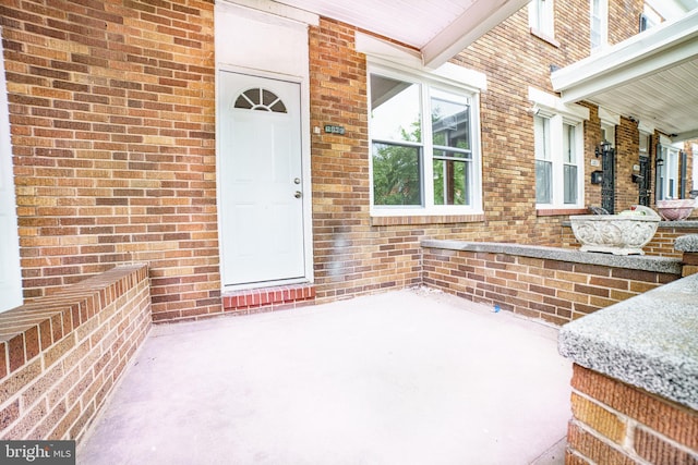 entrance to property with brick siding