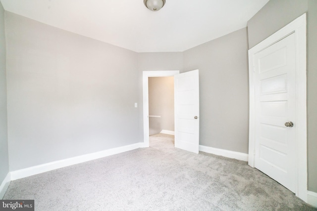 unfurnished bedroom featuring baseboards and carpet floors