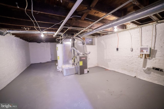 unfinished basement with brick wall, water heater, and heating unit